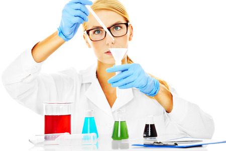A picture of a young scientist working with test tubes over white backgroundの写真素材