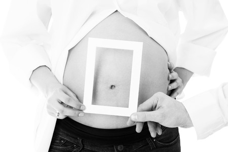 A picture of a pregnant woman showing a fram over her belly