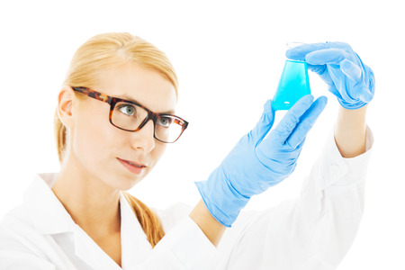 Beautiful female scientist examining  chemical in beaker isolated over white backgroundの写真素材