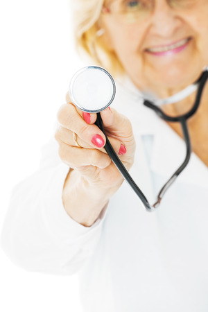 Cropped image of senior female doctor holding stethoscope isolated over white backgroundの写真素材