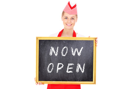 A picture of a pretty waitress showing a board with a now open inscription over white 