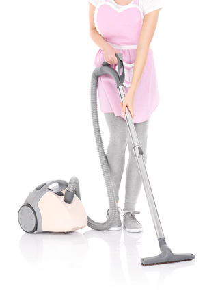 A picture of a woman with a vacuum cleaner over white backgroundの写真素材
