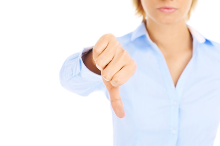 Woman showing negative sign over white backgroundの写真素材