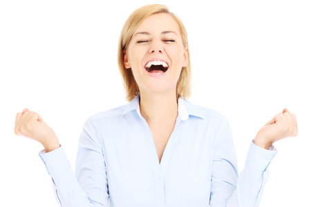 Happy business woman with hands up over white backgroundの写真素材
