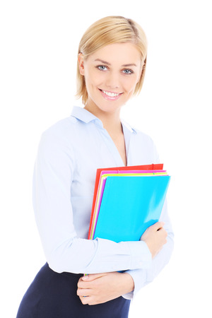 Young nice businesswoman holding files over white backgroundの写真素材