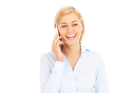 A picture of a young businesswoman with a cellphone over white backgroundの写真素材