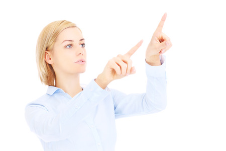 A picture of a young businesswoman pressing buttons over white backgroundの写真素材