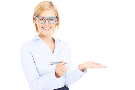 A picture of a happy businesswoman with a pen showing something over white backgroundの写真素材