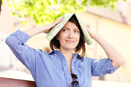 A picture of a lost tourist with a map in a townの写真素材