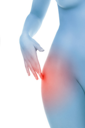 Midsection of female body with hip pain over white backgroundの写真素材