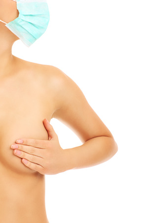 A picture of a woman with a surgical mask showing her breast over white backgroundの写真素材