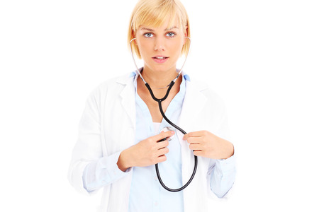 A picture of a young doctor with stethoscope checking heart over white backgroundの写真素材