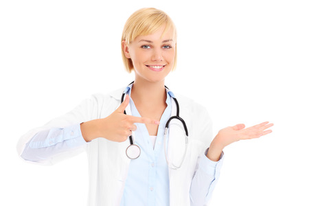 A picture of a young doctor with stethoscope showing something over white backgroundの写真素材