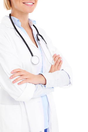 A midsection of a happy doctor with stethoscope over white backgroundの写真素材