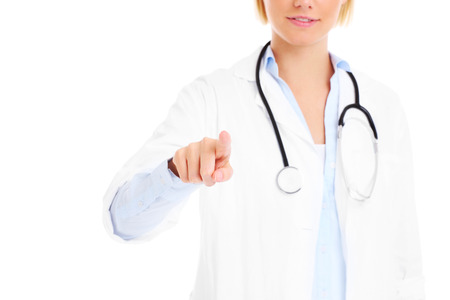 A picture of a young doctor pressing the screen over white backgroundの写真素材