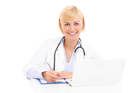 A picture of a young happy doctor with laptop and documents over white backgroundの写真素材
