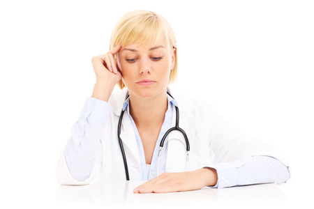 A picture of a stressed doctor sitting over white backgroundの写真素材