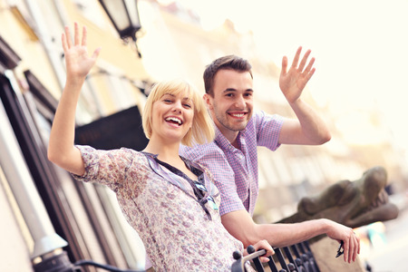 A picture of a happy couple waving to the camera in the Old Town of Gdansk in Polandの写真素材