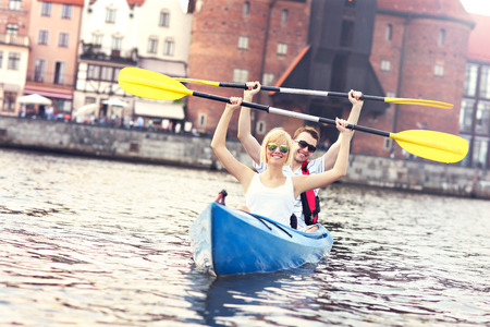 A picture of a young couple in a canoe sigtseeing Gdansk in Polandの写真素材