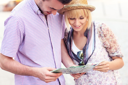 A picture of a young couple sightseeing with a mapの写真素材