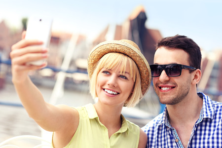 A picture of a happy couple taking pictures of themselves in Gdansk Marinaの写真素材