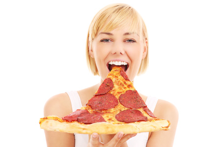 A picture of a happy woman with pizza over white backgroundの写真素材
