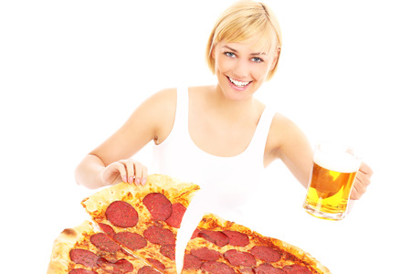 A picture of a happy woman with pizza and beer over white backgroundの写真素材