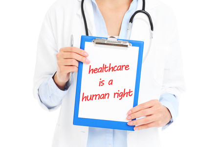 A midsection of doctor holding documents over white backgroundの写真素材