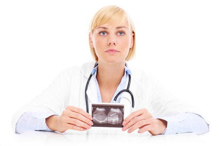 A picture of doctor holding ultrasound over white backgroundの写真素材