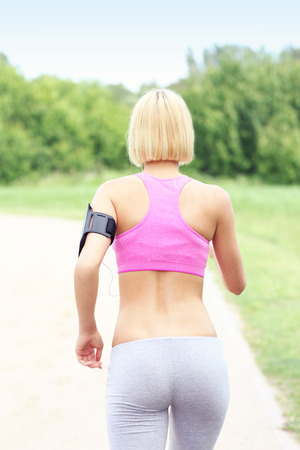 A picture of an active woman jogging in parkの写真素材