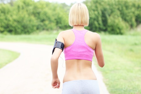 A picture of an active woman jogging in parkの写真素材