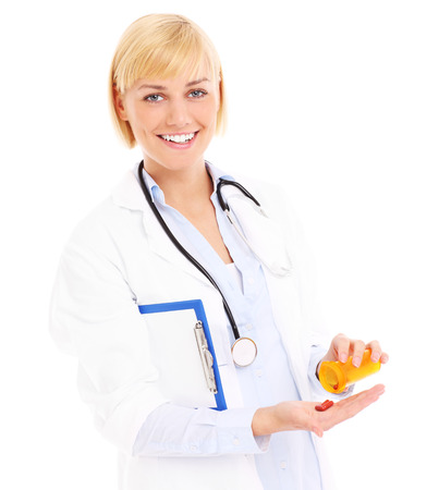 A picture of an adult doctor with stethoscope and pills standing over white backgroundの写真素材