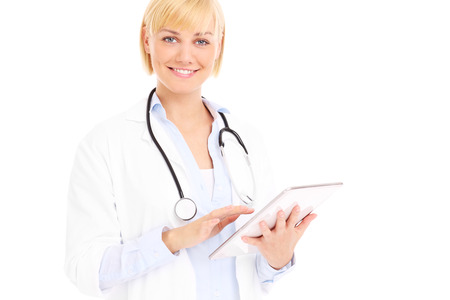 A picture of a young doctor standing with tablet over white backgroundの写真素材