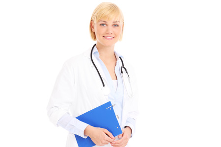 A picture of a young doctor standing with documents over white backgroundの写真素材