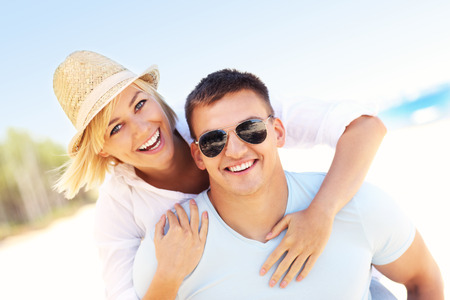 A picture of a joyful couple having fun at the beachの写真素材
