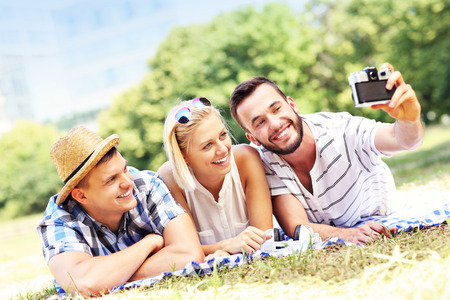 A picture of a group of students taking pictures in the parkの写真素材