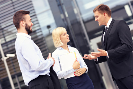 A picture of a group of business people having discussion outside modern buildingの写真素材