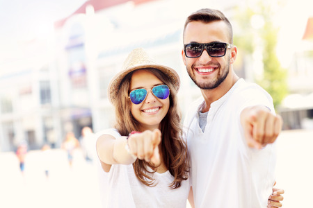 A picture of a happy couple pointing to the camera in Sopotの写真素材