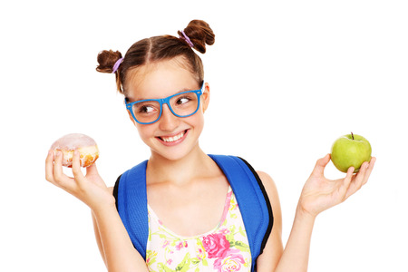 A picture of a schoolgirl with healthy and unhealthy lunch choices over white backgroundの写真素材