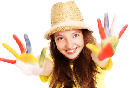 A picture of a joyful girl with paint on her handsの写真素材