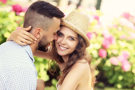 A picture of a romantic couple sitting in the gardenの写真素材