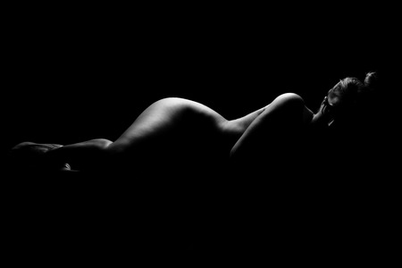 A picture of a sexy woman lying on the floor over black backgroundの写真素材