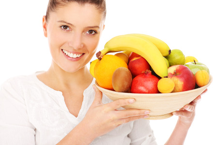 A picture of a happy woman with fruits over white backgroundの写真素材