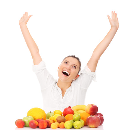 A picture of a happy woman with fruits over white backgroundの写真素材