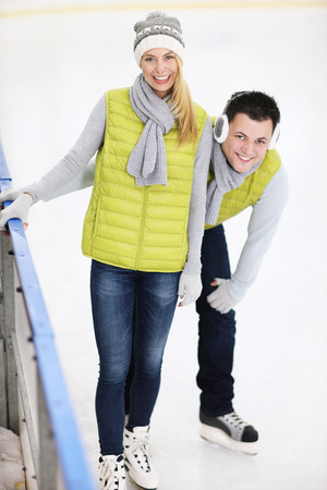 A picture of a happy couple in the ice rinkの写真素材