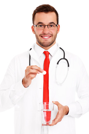 A picture of a doctor holding pill and glass of waterの写真素材