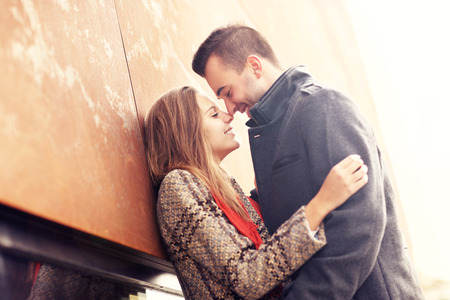 A picture of a romantic couple kissing on an autumn dateの写真素材