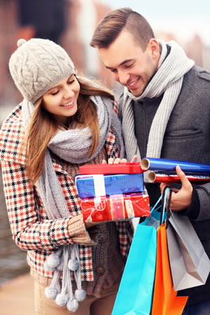 A picture of cheerful young people doing Christmas shoppingの写真素材