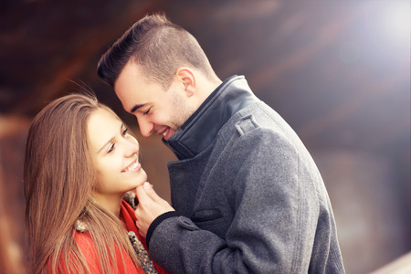 A picture of a romantic couple kissing on an autumn dateの写真素材