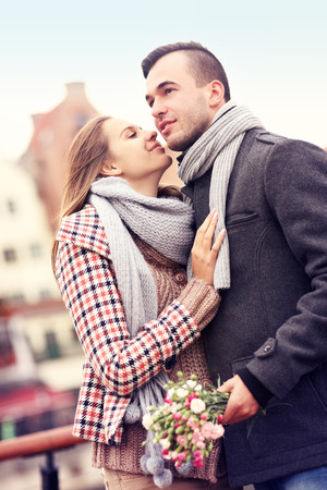 A picture of a romantic couple with flowers on an autumn walkの写真素材